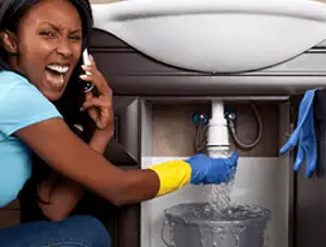 Emergency plumbing repair for a leaking sink drain under a bathroom vanity in Houston, TX