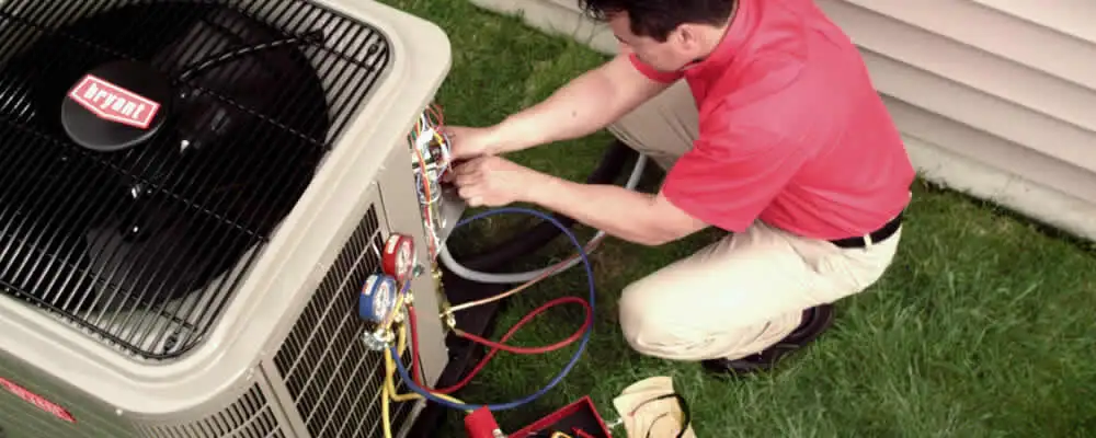 HVAC technician servicing an outdoor air conditioner unit in Houston, TX