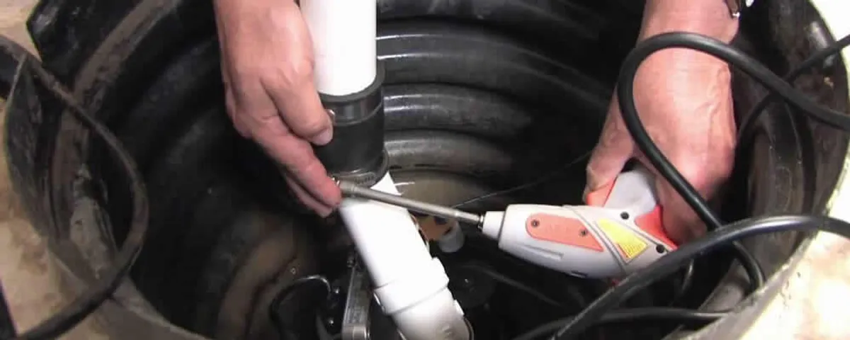 Sump pump installation technician connecting PVC discharge piping in Houston, TX